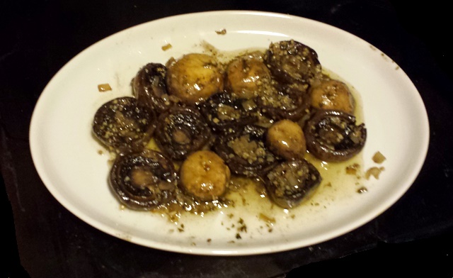 Mushrooms with shallots and garlic and parsley, on a serving platter.