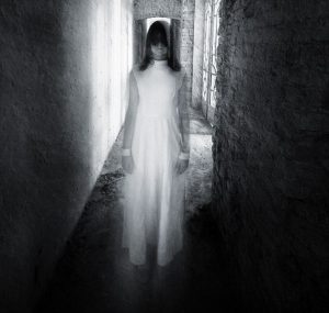 Horror movie scene with a girl dressed in white in a desolated house; Shutterstock ID 149780201; PO: 1259; Job: ghosts