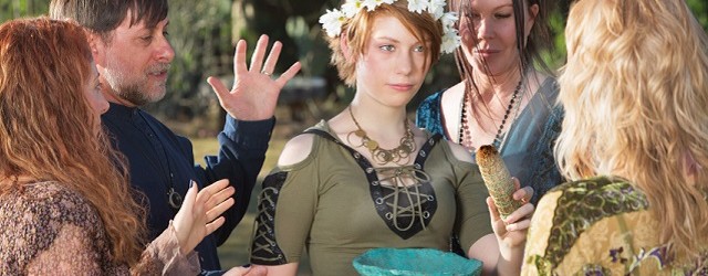 Group of witches outdoors doing an initiation ritual