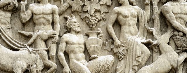 "Rome, Italy - March 3, 2012: detail of bas-relief on the facade of a stage inside CinecittA studios. This photo shows a faun (satyr in the Greek mythology) during the grape harvest. Faun is bound to Dionysus the god of the grape harvest."