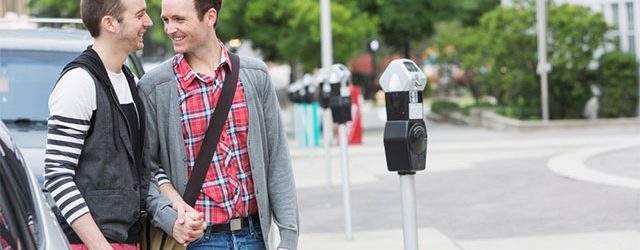 Gay men in city holding hands