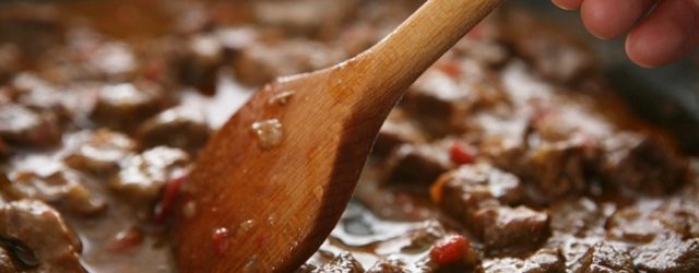 stirring beef stew close up