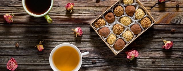 Chocolate candies, coffee, tea and dry roses