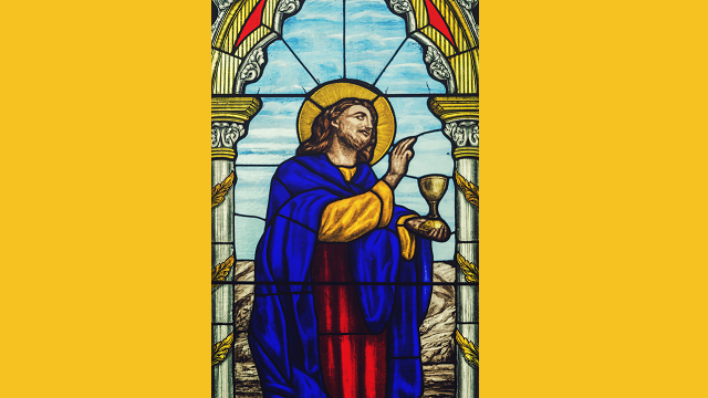 Stained glass image of Jesus holding a cup