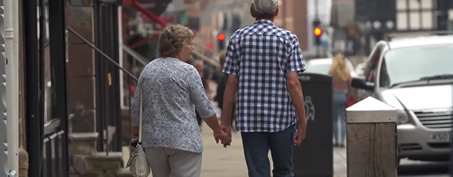 An older couple walking hand in hand