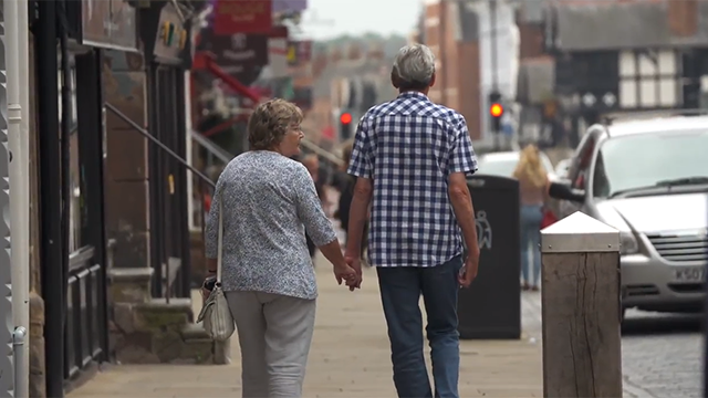 An older couple walking hand in hand