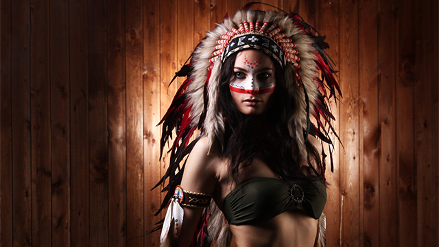 A woman wearing a headdress and face paint