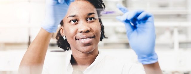 Scientist Looking at a Microscope Slide