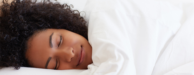 A person smiling in their sleep