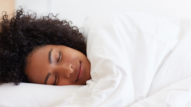 A person smiling in their sleep