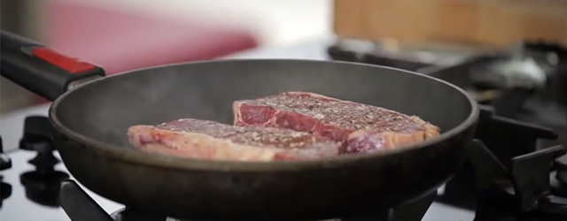 Steak cooking in a skillet