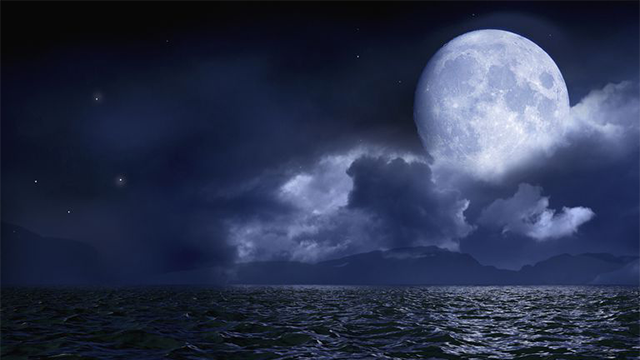 A full moon over the ocean