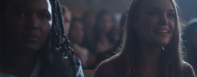A scene from the Motherland teaser showing two young women in an assembly